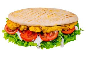Doner kebab - fried chicken meat with vegetables in pita bread photo
