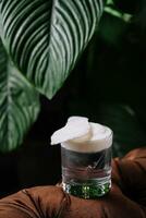 Glass filled with coconut water and foam photo