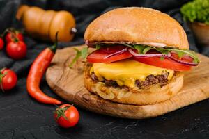 Tasty grilled home made burger with beef, tomato, cheese, onion and lettuce. photo