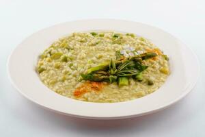 Dish of risotto with asparagus isolated on white plane photo