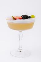 Close up Yellow Cocktail with white foam with berries photo