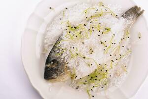 Fish baked in salt on plate photo