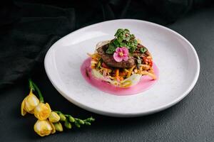 Beef medallions with fresh salad on plate photo