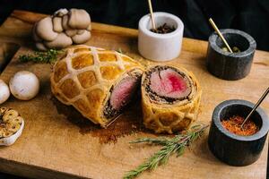 Pork tenderloin in wellington style with mushrooms photo