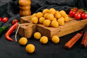 Tasty cheese balls on a wooden Board photo