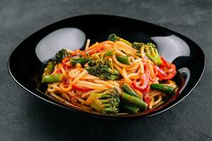 Vegetable and wholewheat spaghetti with green beans, broccoli and pepper photo