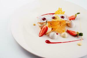 Meringue cake with strawberry on plate photo