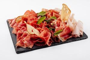 Traditional spanish jamon, prosciutto crudo, italian salami, parma ham photo