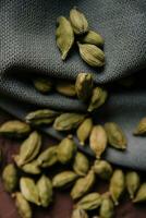 Green aromatic cardamom on fabric close up photo