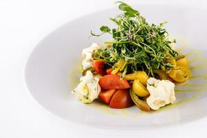 salad of different tomatoes on plate photo