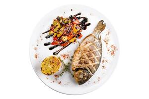 Grilled dorado fish with baked vegetables photo