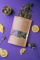 Dried and fresh tea leaves with lemon slices photo