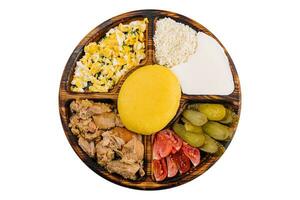 Traditional Moldavian hominy porridge on a wooden tray photo