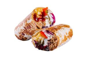 fresh roll of thin lavash or pita bread filled with grilled meat photo