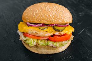 Chicken burger on black stone table photo