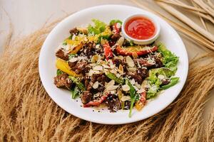 Close up of warm salad with beef and vegetables photo