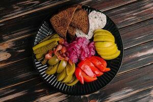 Delicious spicy pickles cut on a serving plate photo