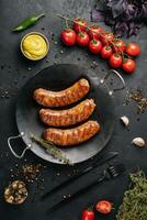 fried sausages on black pan from above photo