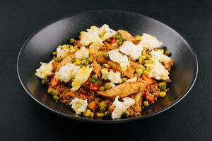 Mediterranean rice dish with eggplant, vegetables, chicken meat and feta cheese photo