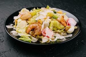 Caesar salad with grilled shrimp and parmesan cheese photo