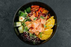 Poke bowl with salmon, cucumber, pepper and orange photo