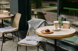 latte coffee with chocolate cake on the terrace of the bar photo