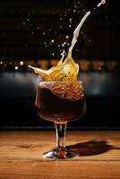 splashes glass of dark Belgian beer photo