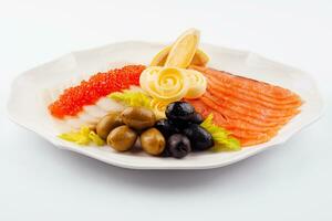 Red and white salted fish in assortment with greenery and lemon photo