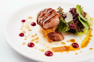 Slices of grilled duck breast fillet with salad photo