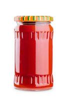 Tasty tomato sauce in glass jar isolated on white photo