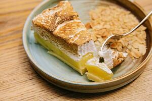 Yummy lemon meringue pie on plate photo