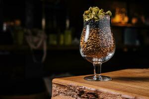 Hops and wheat in a glass for beer photo