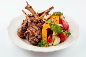 Grilled lamb rack with baked vegetables photo