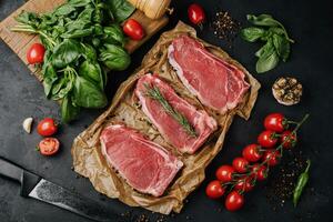 Raw strip loin steaks on baking paper photo