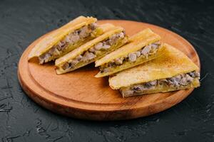 chicken, mushroom and cheese Quesadilla on wooden board photo