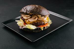 black burger with beef and mushrooms photo