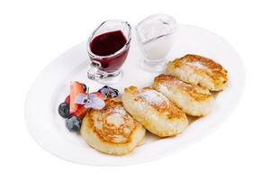 Cottage pancakes with berry jam, sour cream and berries photo