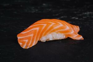 Salmon nigiri sushi on black stone photo