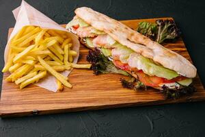 American sandwich baguett with ham steak and french fries photo