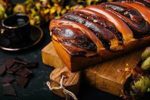 Sweet cinnamon bun on wooden board photo