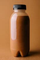 Brown smoothies in a bottle on a brown background photo