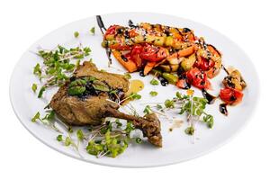 Roasted duck leg with grilled vegetables photo