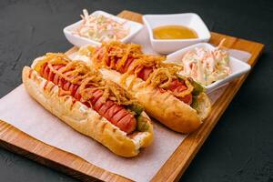 Delicious Gourmet Grilled Hot Dogs With Mustard, Pickles, Onion photo