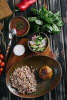 buckwheat with cutlet, borscht and salad photo