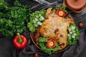Roast chicken with fresh vegetables top view photo