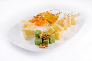 Cheese Platter with Honey, Nuts on white plate photo