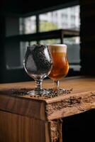 glass of beer and wheat in glass on wooden table photo