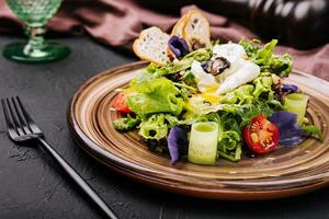 Vegetable salad with poached egg on a plate photo