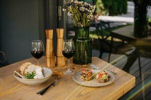 Italian salad with Burrata cheese and tomatoes and bruschetta with pesto sauce photo