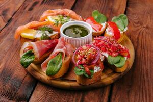 Different bruschetta on a wooden board photo